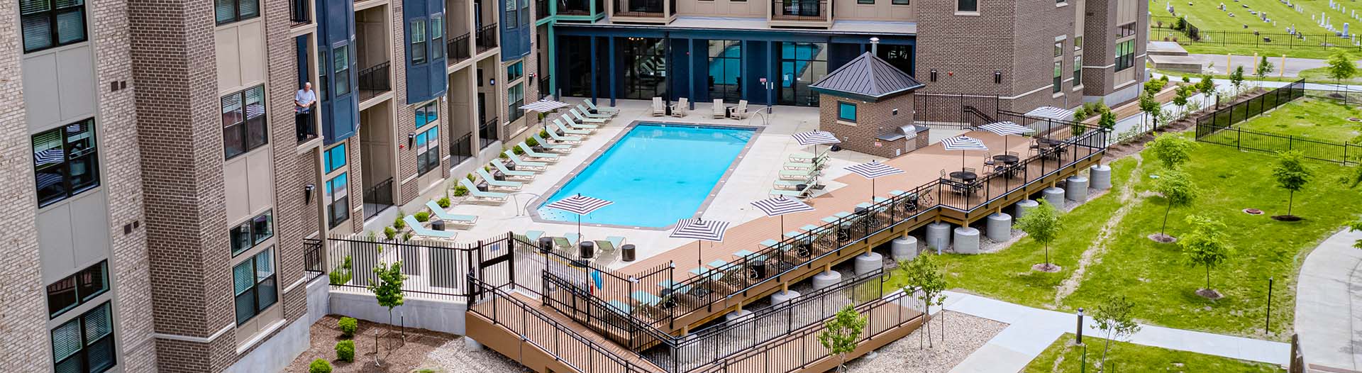 Exterior view of East Bank Apartments and the community pool