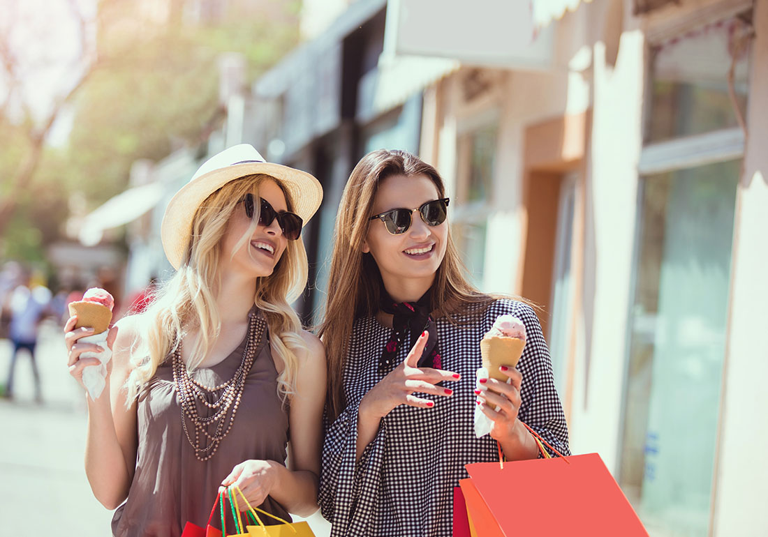 Ladies enjoying shopping and eating ice cream.