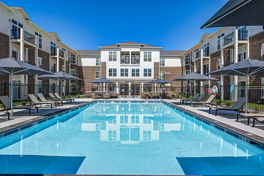 Not sure what a community means by amenities? This pool at Ashley Place Apartments is one example of an amenity. Pristine pool surrounded by apartment buildings at Ashley Place Apartments.